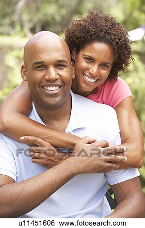 Stock Photograph - Young Couple Outdoors Hugging. Fotosearch