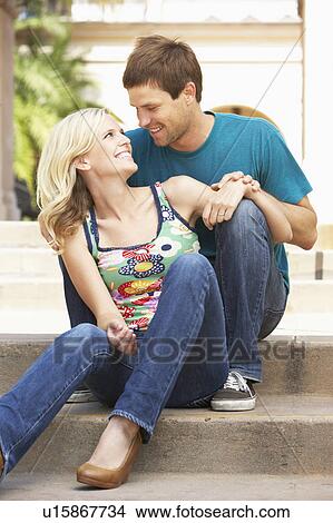 Picture - Young Couple Sitting On Steps Of Building. Fotosearch