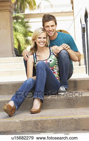 Stock Photo - Young Couple Sitting On Steps Of Building. Fotosearch