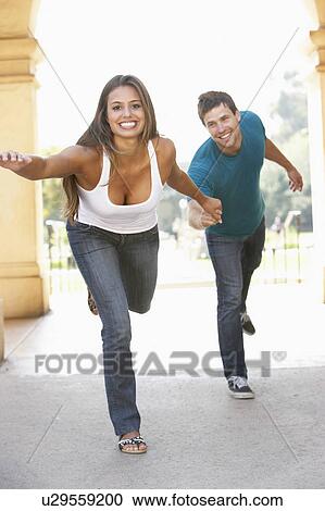 Stock Image - Young Couple Visiting Building In City. Fotosearch