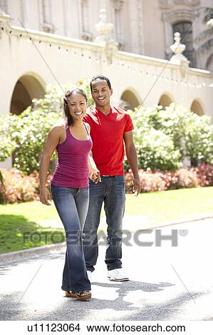 Young Couple Walking Through City Street View Large Photo Image Picture - Young Couple Walking Through City Street. Fotosearch