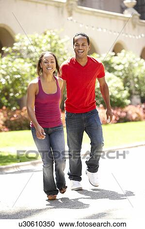 Young Couple Walking Through City Street View Large Photo Image Stock Image - Young Couple Walking Through City Street. Fotosearch