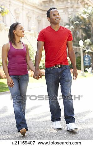 Young Couple Walking Through City Street View Large Photo Image Stock Photo - Young Couple Walking Through City Street. Fotosearch