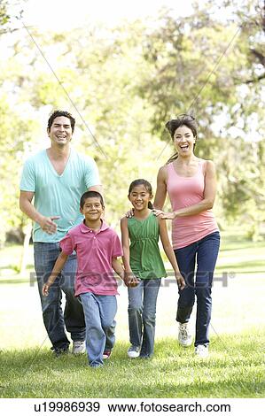 Stock Photo - Young Family Having Fun In Park. Fotosearch