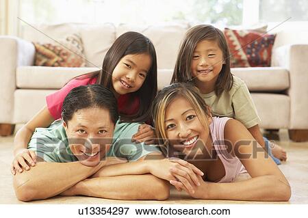 Stock Photo - Young Family Relaxing At Home. Fotosearch