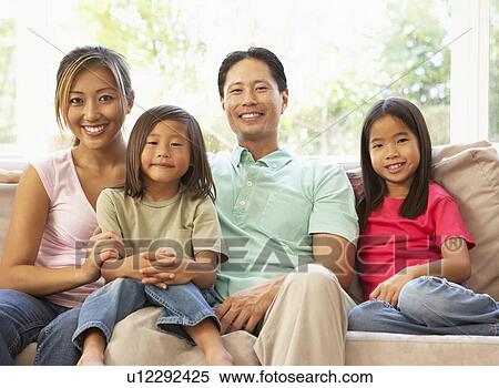 Young Family Relaxing On Sofa At Home View Large Photo Image Stock Photography - Young Family Relaxing On Sofa At Home. Fotosearch