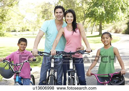 Young Family Riding Bikes In Park View Large Photo Image Stock Photo - Young Family Riding Bikes In Park. Fotosearch
