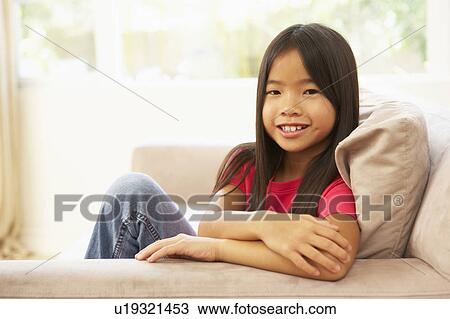 Young Girl Relaxing On Sofa At Home View Large Photo Image Stock Image - Young Girl Relaxing On Sofa At Home. Fotosearch