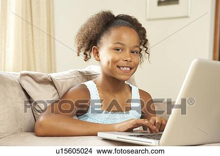 Young Girl Using Laptop At Home View Large Photo Image Picture - Young Girl Using Laptop At Home. Fotosearch