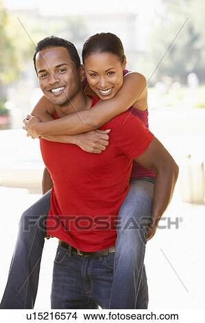Young Man Giving Woman Piggyback Outdoors View Large Photo Image Picture - Young Man Giving Woman Piggyback Outdoors. Fotosearch