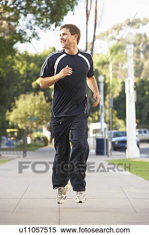 Stock Photography - Young Man Jogging On Street. Fotosearch
