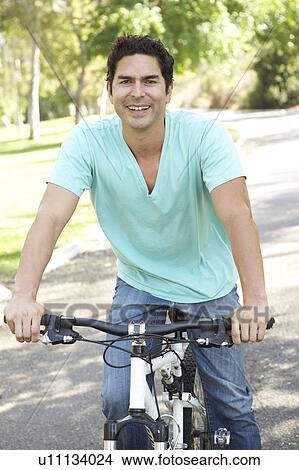 Young Man Riding Bike In Park View Large Photo Image Picture - Young Man Riding Bike In Park. Fotosearch