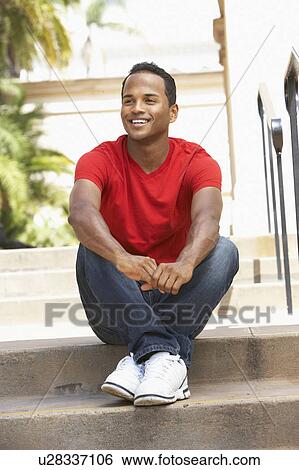Young Man Sitting On Steps Of Building View Large Photo Image Stock Photograph - Young Man Sitting On Steps Of Building. Fotosearch