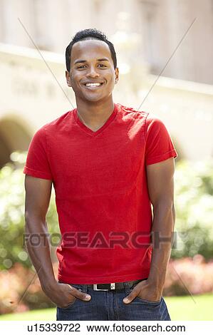 Stock Image - Young Man Walking Through City Street. Fotosearch