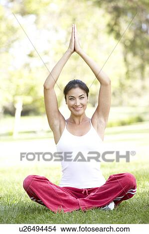 Picture - Young Woman Doing Yoga In Park. Fotosearch