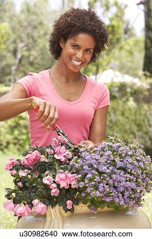 Stock Image - Young Woman Gardening. Fotosearch