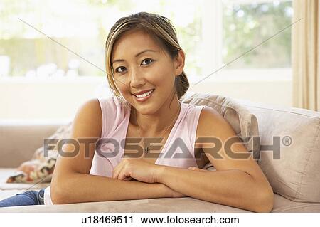 Young Woman Relaxing On Sofa At Home View Large Photo Image Stock Image - Young Woman Relaxing On Sofa At Home. Fotosearch