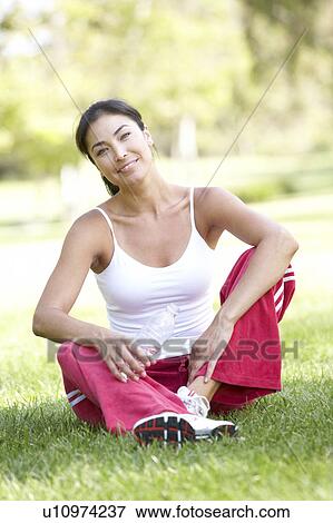 Stock Photo - Young Woman Resting After Exercise. Fotosearch