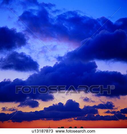 Stock Image - dusk, dark clouds, black clouds, sky, sunrise, sunset. Fotosearch