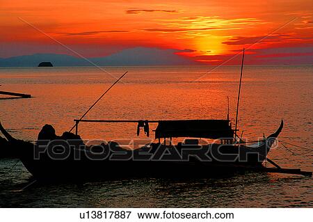 Stock Photo - Sunset, Sea, Sunset in Anilao, Blue, Diving Vacation, Nature landscape, Anilao. Fotosearch