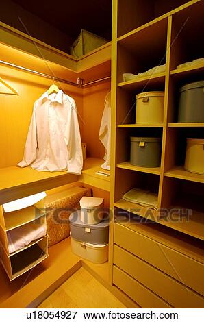 A white shirt hanging in a closet View Large Photo Image Stock Photo - A white shirt hanging in a closet. Fotosearch