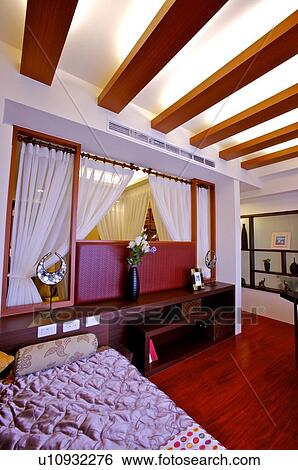 Bedroom with a cupboard, with flowers and ornaments on it View Large Photo Image Stock Photograph - Bedroom with a cupboard, with flowers and ornaments on it. Fotosearch