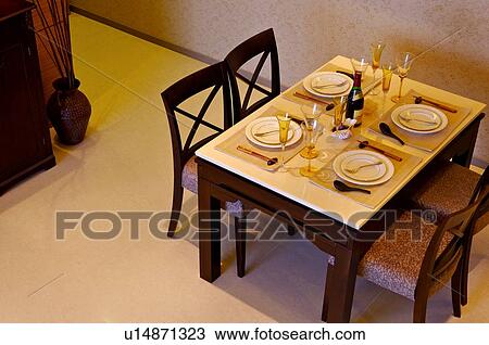 Dining table set with plates, utensils, glasses, and a bottle of champagne View Large Photo Image Stock Image - Dining table set with plates, utensils, glasses, and a bottle of champagne. Fotosearch
