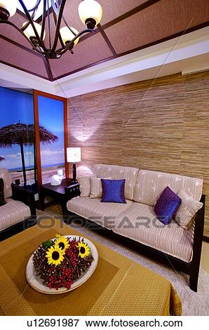 Living room with sofa and table with a flower centerpiece View Large Photo Image Stock Photo - Living room with sofa and table with a flower centerpiece. Fotosearch
