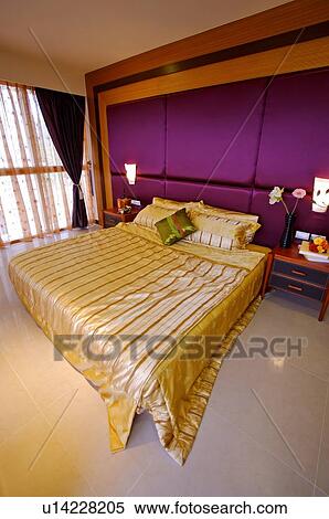 Modern bedroom with a made bed, and small tables beside the bed View Large Photo Image Stock Photography - Modern bedroom with a made bed, and small tables beside the bed. Fotosearch