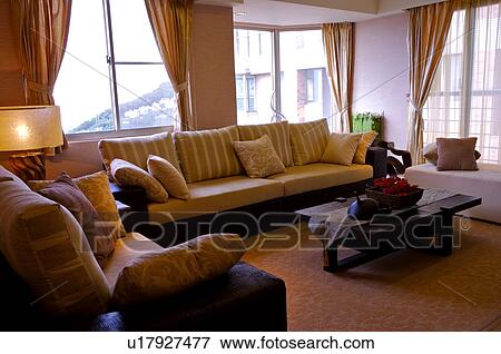 Modern, comfortable living room with natural lighting, and lamps View Large Photo Image Stock Photo - Modern, comfortable living room with natural lighting, and lamps. Fotosearch