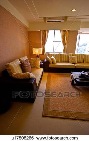 Stock Photograph - Modern living room with natural and artificial light, with a large carpet in the middle. Fotosearch