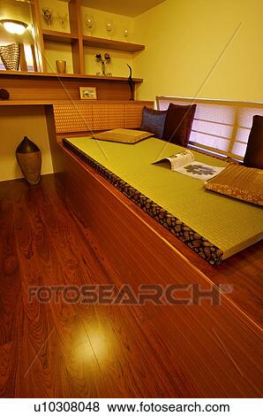Stock Photo - Modern room with a mat and cushions, and ornaments. Fotosearch
