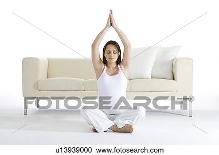 Pregnant woman sitting on floor cross legged, hands above head View Large Photo Image Stock Image - Pregnant woman sitting on floor cross legged, hands above head. Fotosearch