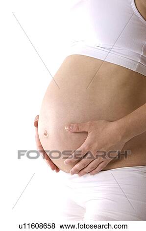 Pregnant young woman, hands resting on abdomen, close-up View Large Photo Image Stock Photo - Pregnant young woman, hands resting on abdomen, close-up. Fotosearch