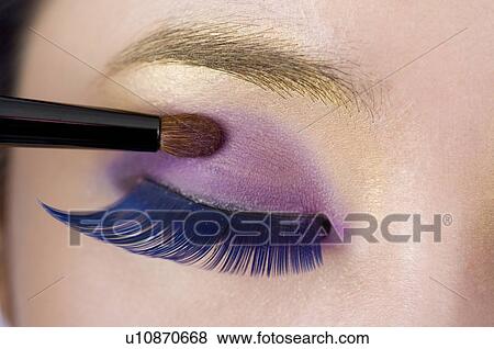 A woman with green eyebrows applying purple eye shadow View Large Photo Image Stock Photo - A woman with green eyebrows applying purple eye shadow. Fotosearch