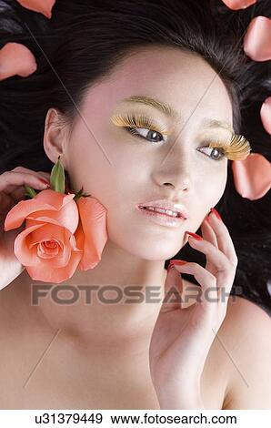 Chinese woman with petals on hair View Large Photo Image Stock Photo - Chinese woman with petals on hair. Fotosearch