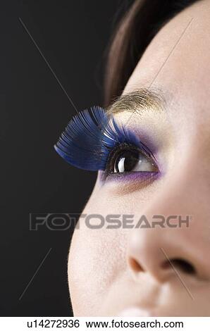 Stock Photograph - Close-up of a young woman's blue fake eyelash. Fotosearch