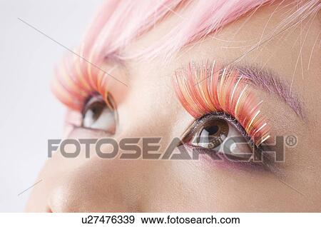 Close up of a young women's wearing long false pink eyelashes View Large Photo Image Stock Photo - Close up of a young women's wearing long false pink eyelashes. Fotosearch