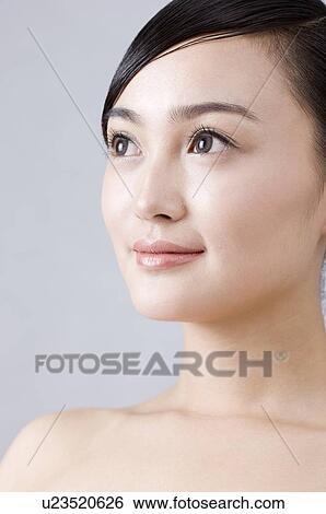 Stock Photograph - Side view of a young woman. Fotosearch