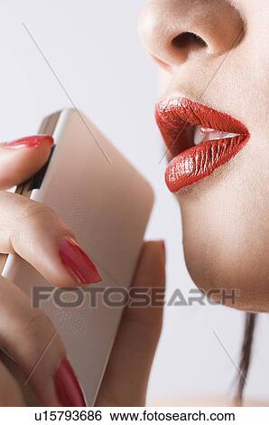 Young woman holding mobile phone View Large Photo Image Stock Photograph - Young woman holding mobile phone. Fotosearch
