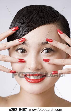 Young woman putting her hand on the bilateral of her eyes View Large Photo Image Stock Photo - Young woman putting her hand on the bilateral of her eyes. Fotosearch