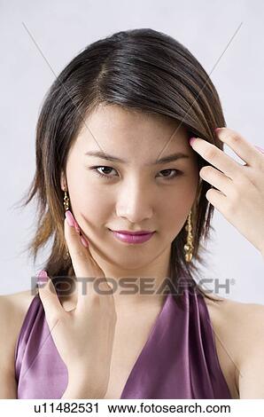 Young woman raising her fringe View Large Photo Image Stock Image - Young woman raising her fringe. Fotosearch