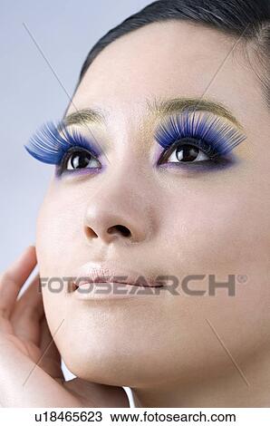 young woman wearing false blue eyelash View Large Photo Image Stock Image - young woman wearing false blue eyelash. Fotosearch