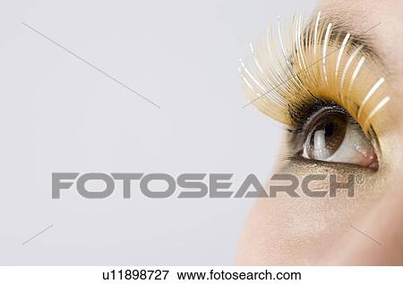 Young woman wearing long false eyelash View Large Photo Image Stock Photo - Young woman wearing long false eyelash. Fotosearch