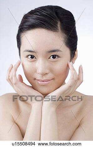 Young woman with face between her hands View Large Photo Image Picture - Young woman with face between her hands. Fotosearch