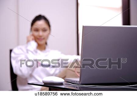 Stock Photograph - Close up of young woman's laptop. Fotosearch