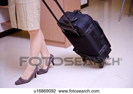 Young woman leaving with suitcase View Large Photo Image Stock Image - Young woman leaving with suitcase. Fotosearch