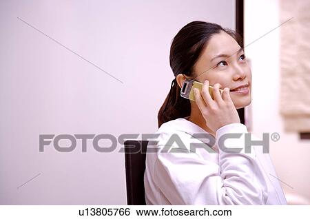 Young woman on the phone View Large Photo Image Stock Photograph - Young woman on the phone. Fotosearch