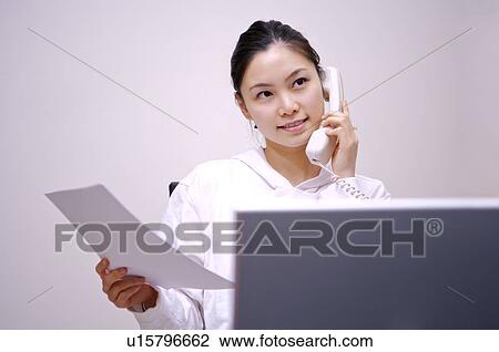Young woman working at home View Large Photo Image Stock Image - Young woman working at home. Fotosearch