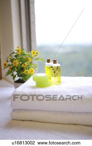 Aromatherapy oil and chrysanthemum on the top of folded towel View Large Photo Image Stock Image - Aromatherapy oil and chrysanthemum on the top of folded towel. Fotosearch